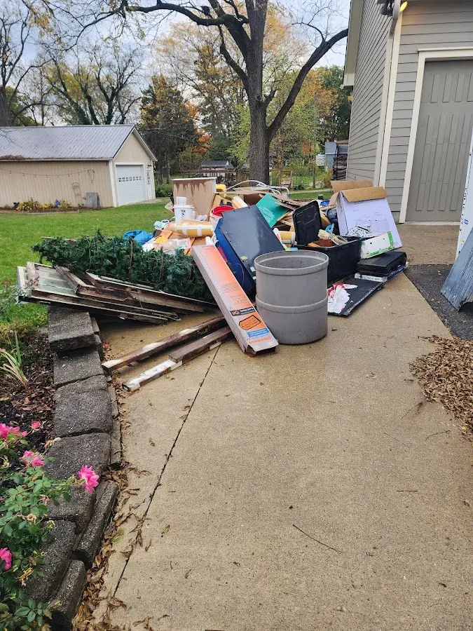 Dumpster being loaded with debris for 10 Yard Dumpster Rental in Mecca